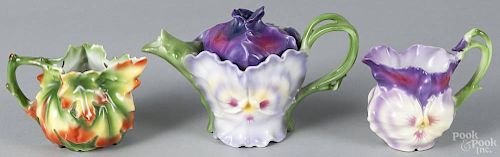 Royal Bayreuth porcelain pansy teapot, 5'' h., and creamer, 3 1/2'' h., each with a blue mark on bases