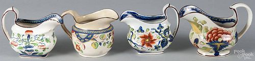Four Gaudy Dutch porcelain cream pitchers, 19th c., in the sunflower, single rose, carnation
