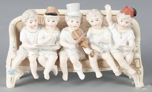 Bisque figural group, 19th c., of a bench with children playing music and singing, 4'' h., 6 1/4'' w.