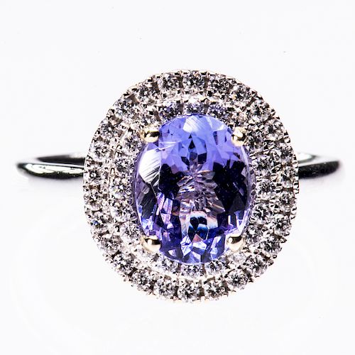 AN 18CT WHITE GOLD TANZANITE AND DIAMOND RING, the oval cut