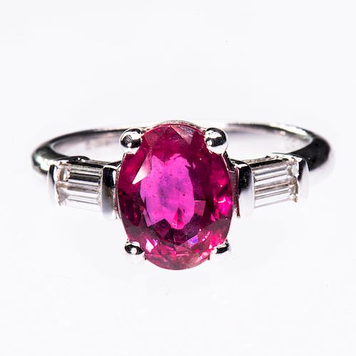 AN 18CT WHITE GOLD RUBY AND DIAMOND RING, the oval cut ruby