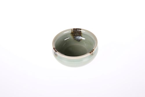 A SMALL CHINESE CELADON GLAZED BOWL, circular, with everted