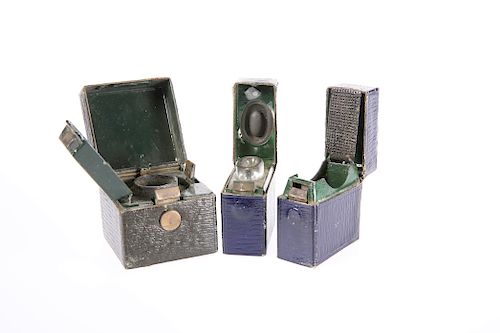 THREE EDWARDIAN TRAVELLING INKWELLS, each leather covered a