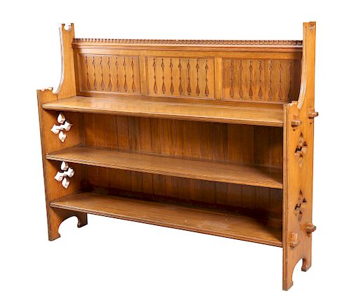 AN ARTS AND CRAFTS OAK OPEN BOOKCASE, the top with three pa