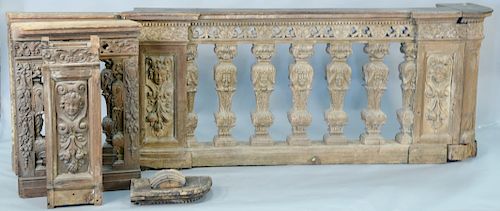 Carved victorian railing having large spindle with carved wheat design and carved panels with putti figures.