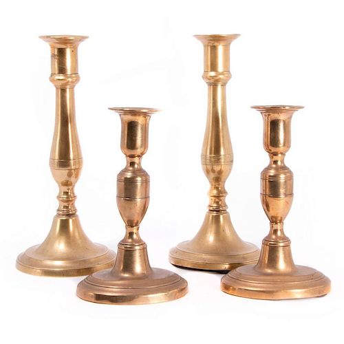 Two pair of brass candlesticks.