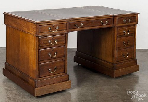 English mahogany desk, late 19th c., mounted on a later pedestal frame with castors