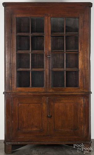 Pennsylvania walnut one-piece corner cupboard, early 19th c., 87'' h., 49'' w.
