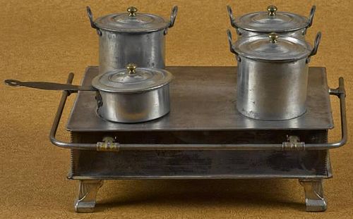 Tin toy stove, probably German, 3 1/2'' h., 11'' w.