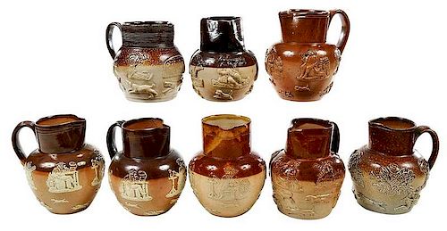 Eight Small Sprig Decorated Stoneware Pitchers