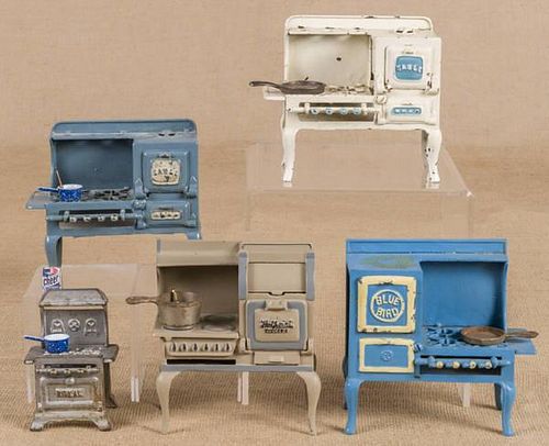 Five cast iron toy stoves, to include two Hubley