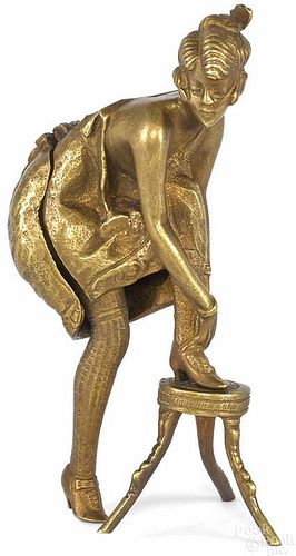 Figural bronze of a woman with her foot on a stoo