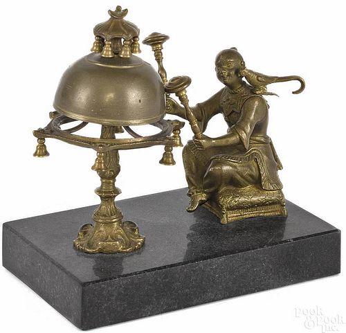 Bronze and marbled animated countertop bell of an