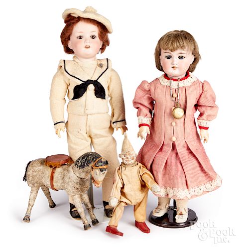 Two bisque dolls and their toys