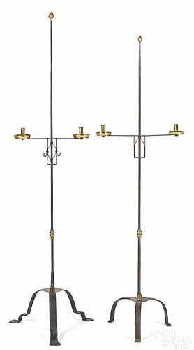 Two wrought iron and brass floor standing candleh