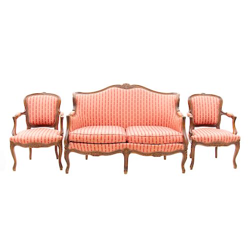 Sala. Francia. SXX. En madera de nogal. Consta de: loveseat y 2 sillones. Con respaldos cerrados y asientos en tapicer’a rosada y roja.