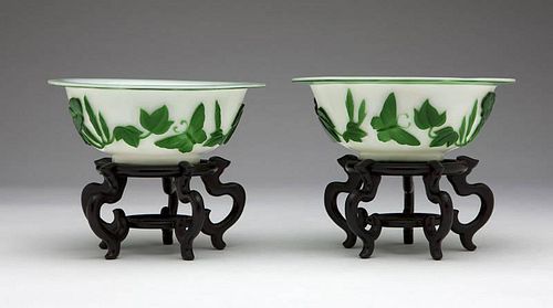 A pair of Chinese glass green and white overlay bowls