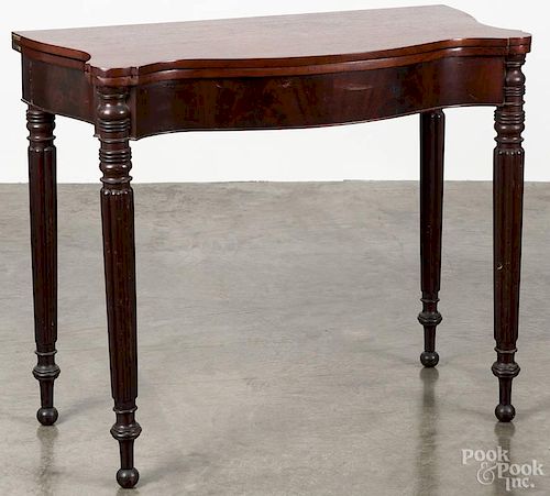 Sheraton mahogany games table, early 19th c., with a serpentine front, 30 1/4'' h., 36'' w.