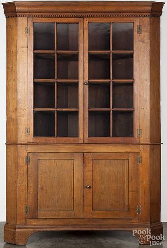 One-piece cherry corner cupboard, ca. 1800, with dentil molding, 87'' h., 55'' w.