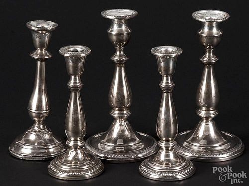 Five sterling silver weighted candlesticks, 20th c., to include two pairs