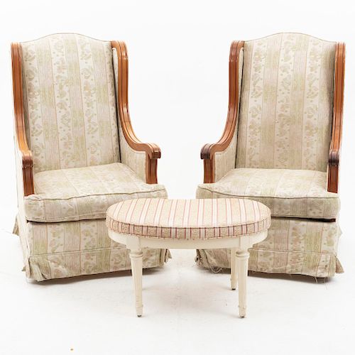 Par de sillones y taburete. Siglo XX. En talla de madera. Con respaldos cerrados y asientos en tapicería rayada y floreada.