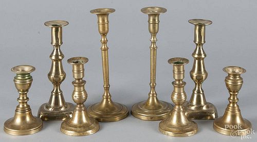 Four pairs of English brass candlesticks, 19th c., 9'' h., 8'' h., 6'' h., and 5'' h.
