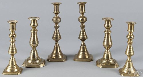 Three pairs of English brass beehive candlesticks, 19th c., 9'' h., 7 3/4'' h., and 7 1/2'' h.