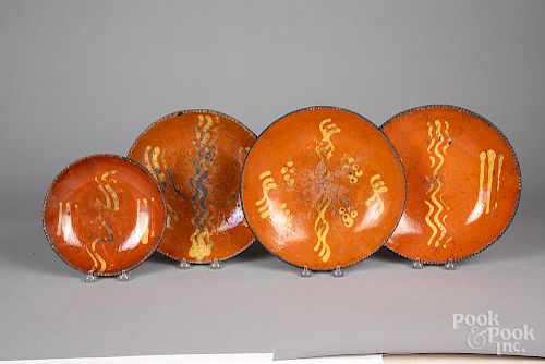 Four Pennsylvania redware plates