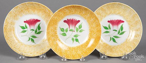 Three yellow spatter thistle saucers