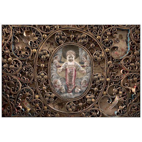 RELIQUARY. FRANCE, CA. 1900. In golden metal and polychrome, cardboard and cloth. With central image of Baby Jesus and relics around it.