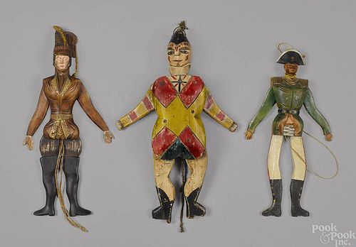 Three carved and painted wood jumping jack toys,