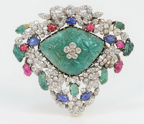 Platinum and 14 Karat Gold Large Brooch, mounted with center shaped emerald (32 x 24 x 14 millimeters), seven emerald leaves (6-10 millimeters), six r