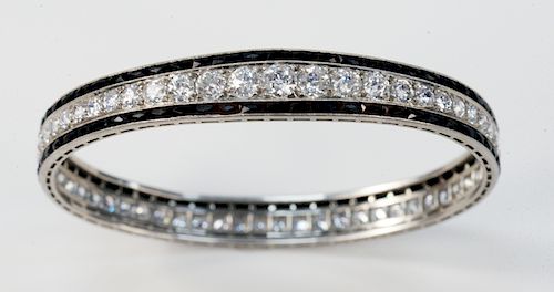 Platinum Bangle Style Bracelet, set with fifty-eight European cut diamonds in center tapering from approximately .65 carats at center to .25 carats at
