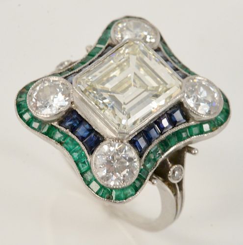Platinum ring, center set with one Emerald cut diamond measuring approximately 9.32 x 8.20 x 4.80mm, with an approximate carat weight of 3.12 by formu