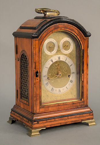 An English Sycamore, Ebonized and Tulipwood - banded Bracket Clock, 19th century, arched case with carrying handle, engraved brass dial with silvered 