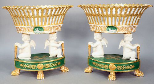 Pair of Sevres Style Porcelain Oval Compotes, neoclassical style consisting of gilded pierced basket, supported by two bisque putti figures, holding g