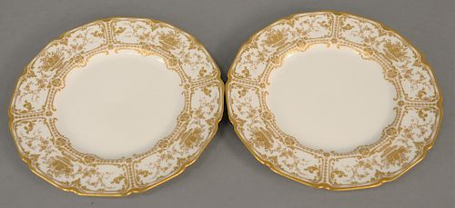 Twelve Royal Doulton Gilt Decorated Plates, 20th century, puce crowned lion and monogram marks. diameter 10 1/2 inches.