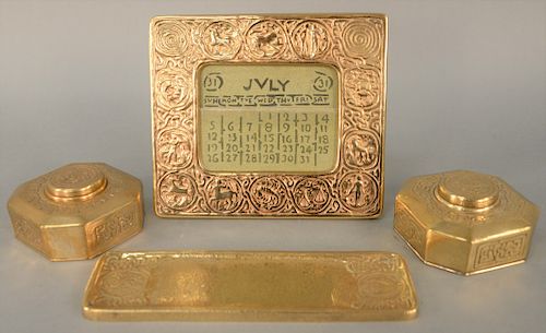 Four Piece Tiffany Desk Lot, Zodiac pattern, to include bronze pen tray, two inkwells and desk calendar, numbers 842 1000 941 each marked Tiffany Stu