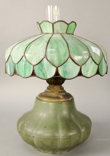 Hampshire Arts and Crafts Table Lamp, having green matte glazed melon form pottery base with oil font, and leaded glass shade, base marked Hampshire, 