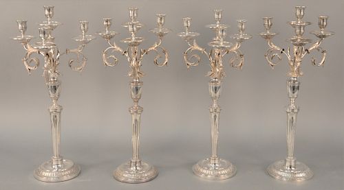 Set of Four German Silver Four Light Candelabra, 19th century, each with four candleholders on scrolled arms foliate decorated set on columns on large