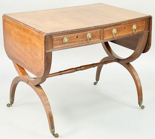 A Regency Mahogany and Rosewood Sofa Table, Charles X base, rectangular top and rounded drop leaves, rosewood banded panels, above a pair of drawers m