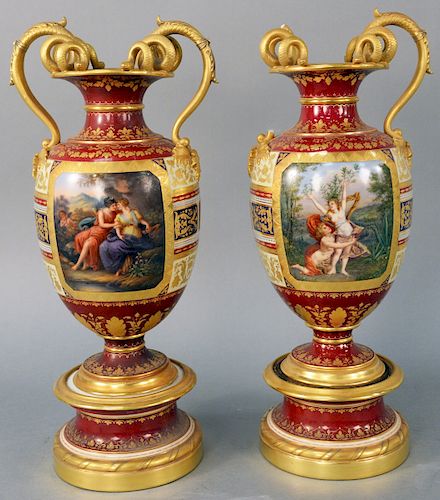Pair of Royal Vienna Snake Handled Urns, having maroon ground, decorated with classical scenes, raised gilt decoration and double gilt snake handles, 