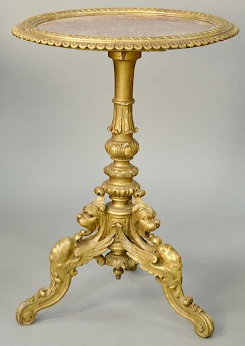 French Carved and Giltwood Circular Marble Top Stand, with a pierced mottled rouge marble top vigorously carved tripartite pedestal on winged griffin 