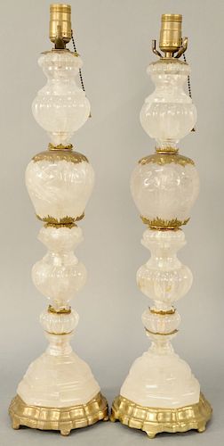 Pair of Rock Crystal Table Lamps, carved rock crystal shaft with metal mounts on shaped brass base. height 26 inches.