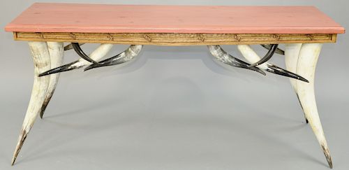 Milo Marks Hall Table, having Longhorn Steer legs, carved skirt and red stained top, marked Milo Marks Meridian. height 31 inches, top: 22" x 68".