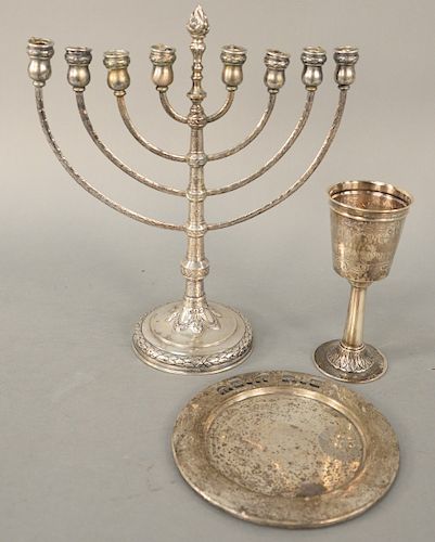 Three Silver Judaic Pieces, Kiddush cup with incised Hebraic letters, silver menorah marked 800 and a small sterling plate with pierced letters. kiddu