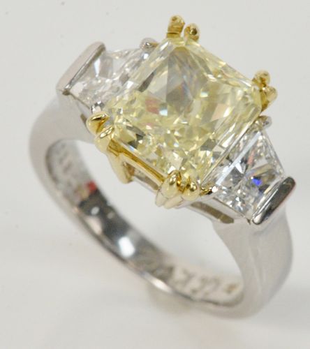 Platinum and Diamond Ring Set, having a 3.52 carat cut diamond flanked by two trapezoid cut diamonds, natural, fancy light yellow, clarity SI1, 8.70 x