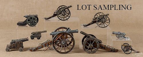 Fourteen toy and miniature cannons.