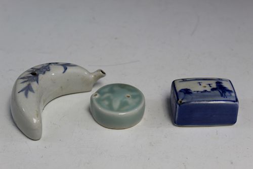 A group of three porcelain water droppers.