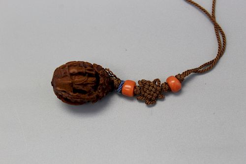 A carved walnut toggle.